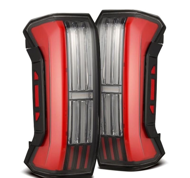 AlphaRex Nova-Series LED tail lights for Toyota Tundra 22-24, black and red prismatic design, featuring modern LED headlights.