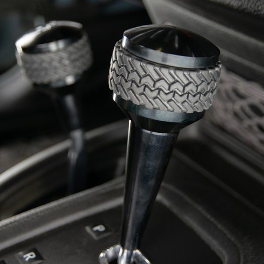 Black DV8 Offroad automatic shift knob for 2011-2018 Jeep JK, stylish gear shift accessory with modern design.