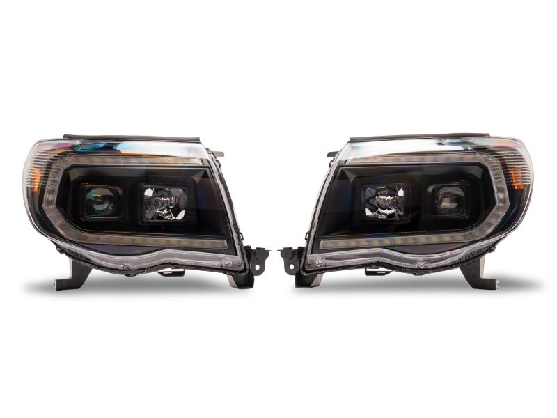 Raxiom black housing projector headlights with clear lenses for 2005-2011 Toyota Tacoma, featuring switchback LED turn signals.