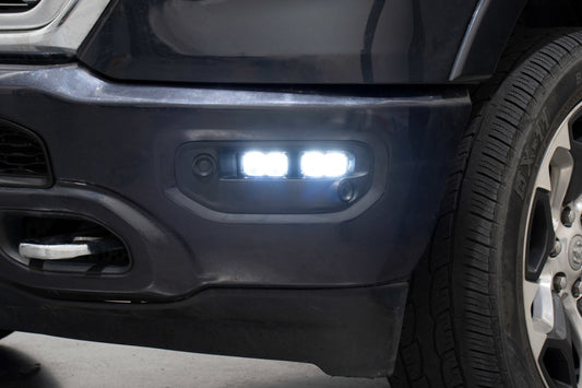 Diode Dynamics SSC2 LED fog lights kit for 2019-present Ram, yellow sport fog lights installed on front of vehicle.