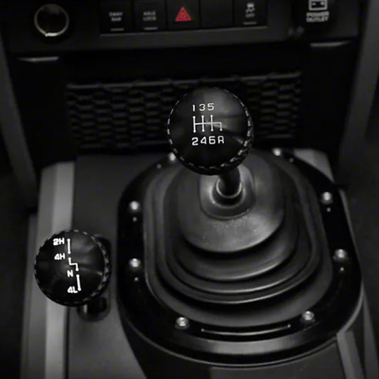 Black DV8 Offroad Jeep JK 6-speed shift knob for 2011-2018 models, shown on a vehicle gear shift.