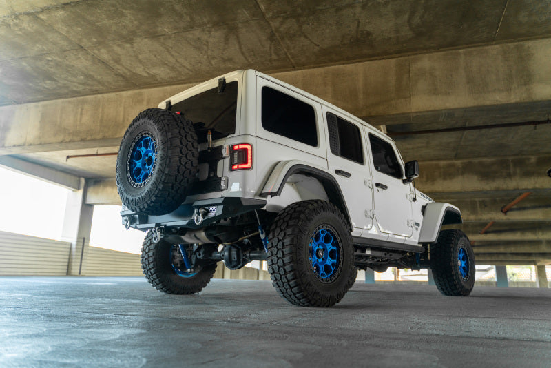 Steel rear bumper for 2018 Jeep Wrangler JL by DV8 Offroad with integrated tire carrier in a rugged off-road design