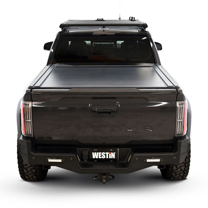 Westin 24-26 Toyota Tacoma black manual roll-up tonneau cover on 5ft truck bed, made for easy retractable protection.