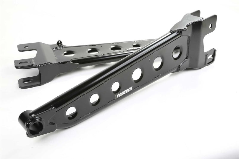 Fabtech Ford F250/F350 and F450/F550 4WD lift kit with radius arm system, showing lifted truck with large tires and suspension components