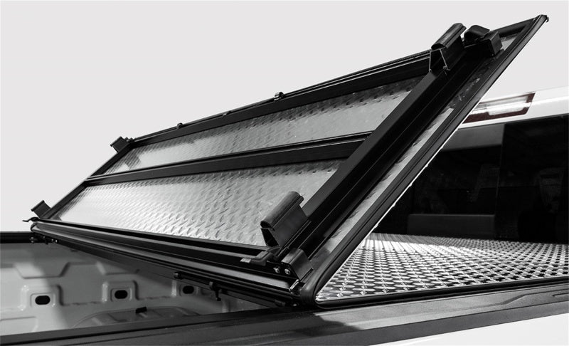Access LOMAX tri-fold black urethane truck bed cover on Chevrolet Silverado 1500 with 6ft 6in bed, exterior truck bed accessory.
