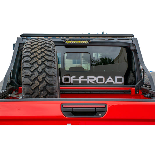 DV8 Offroad Jeep Gladiator chase rack mounted on 2019+ model, sturdy black bolt-on offroad accessory with protective bars.