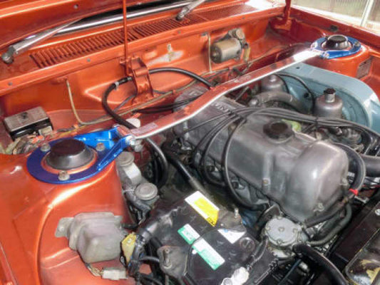 Cusco Type-II Oval Strut Bar installed on a 1967-1973 Datsun 510/Bluebird 1.6L with SU twin carburetors, showing its sleek blue finish