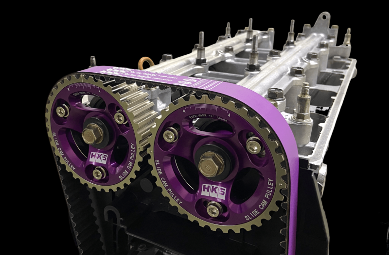 HKS slide cam pulley for B16 and B18C engines, showcasing the black cam gear with detailed HKS branding and metal construction.