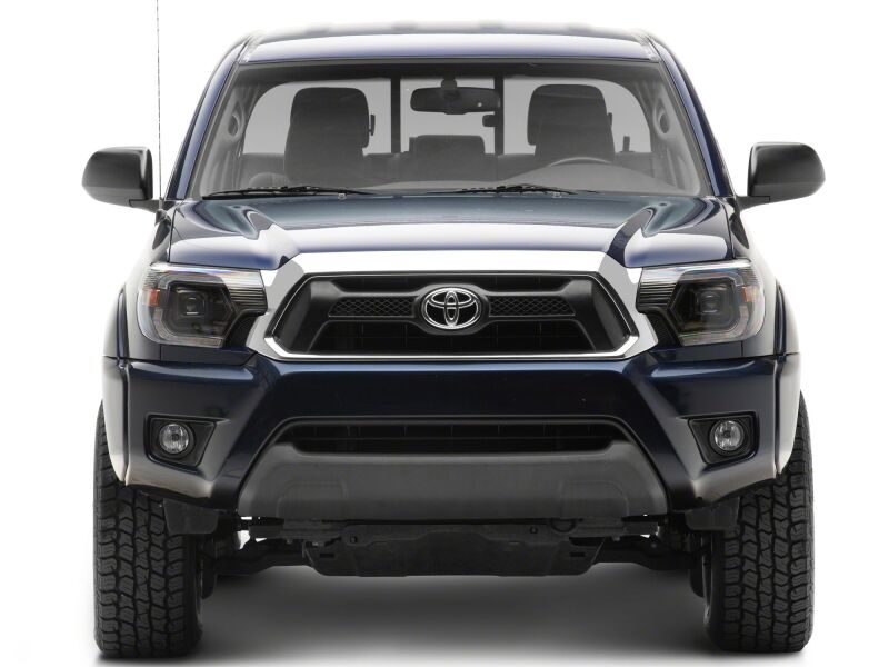 Raxiom Toyota Tacoma 12-15 projector headlights with black housing and clear lens, featuring switchback LED turn signals.