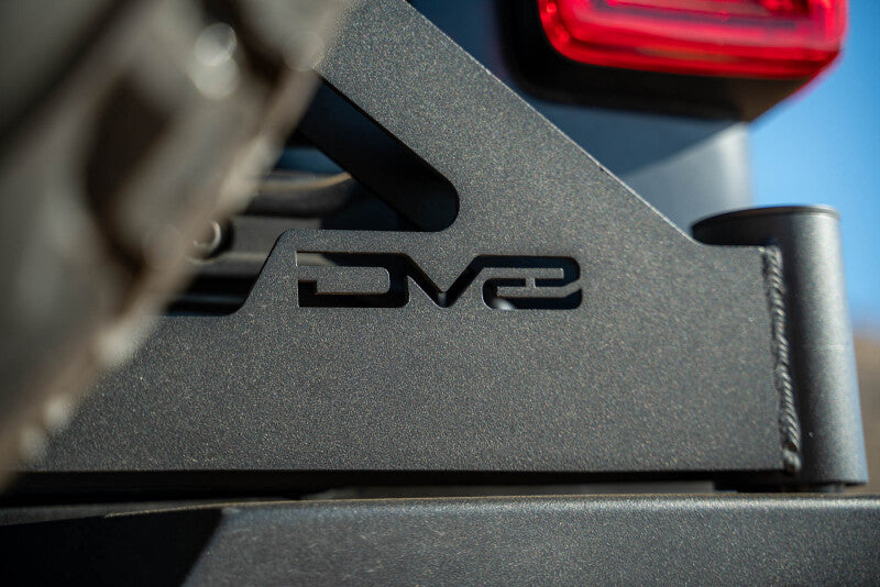 DV8 Offroad Jeep Wrangler JL MTO Series bumper spare tire swing gate tailgate accessory, showing the sturdy metal construction.