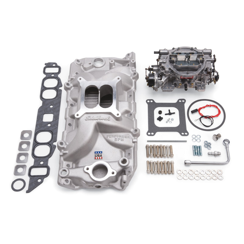 Edelbrock Performer RPM Big Block Chevrolet oval port intake manifold and carb kit in natural finish, detailed view of the components.