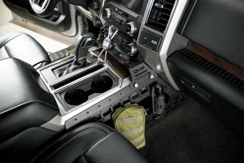 DV8 Offroad Ford F150/F250/F350 center console Molle panels and device mount on exterior trim, designed for rugged truck storage.