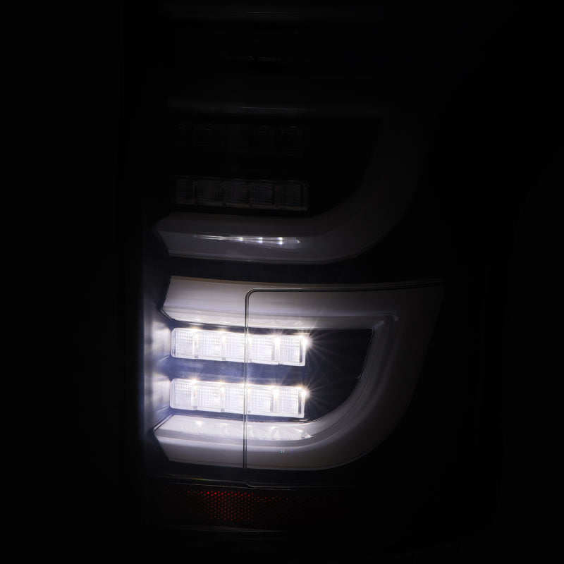 AlphaRex Luxx-Series LED tail lights for Ford F150 2015-2020 in black, showing sleek design and bright illumination.