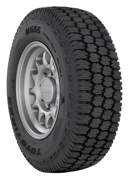 Toyo M655 11R24.5 off-road UTV tire with durable tread and sidewall, designed for on-road automotive use.
