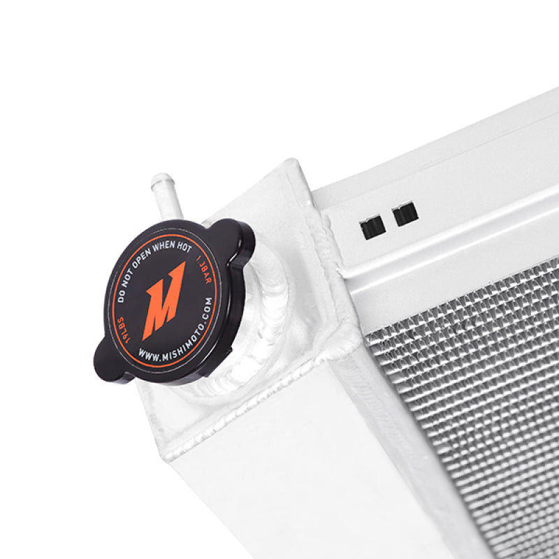 Mishimoto 78-86 GM C/K Truck X-Line aluminum radiator with cooling fins and inlet/outlet hoses, designed for performance cooling.