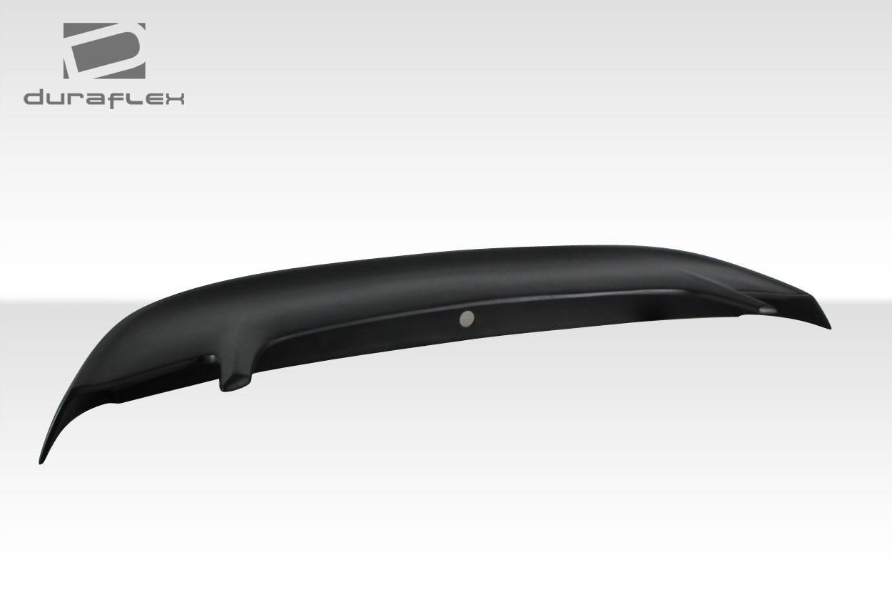 Duraflex Colt rear wing for 1999-2004 Ford Mustang, aerodynamic car wing with sleek design and mounting brackets visible.
