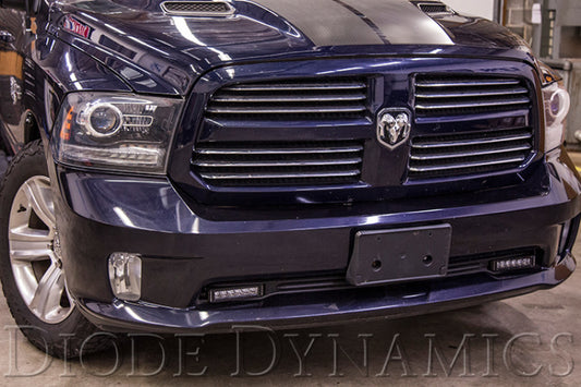 Diode Dynamics Ram 2013 SportExpress Amber Driving Light Bars and Cubes kit installed in a vehicle for enhanced visibility.