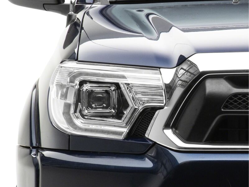 Raxiom Toyota Tacoma Axial Series switchback projector headlights in chrome with clear lenses, designed for 2012-2015 models.