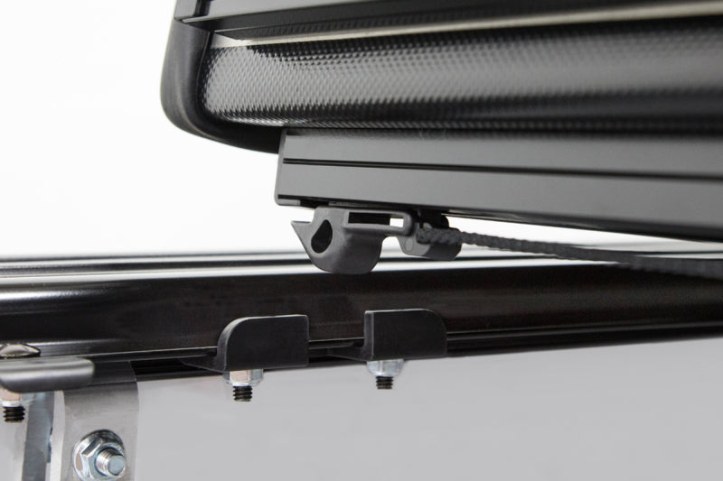 Access LOMAX Pro Series tri-fold hard tonneau cover for Chevy/GMC 1500 6ft 6in bed in black diamond mist finish.