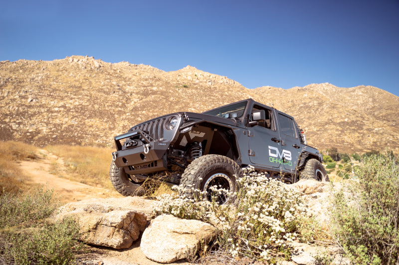 Steel DV8 Offroad FS-25 Stubby Front Bumper with plated bull bar on Jeep Wrangler and Gladiator JT/JK/JL, off-road ready.