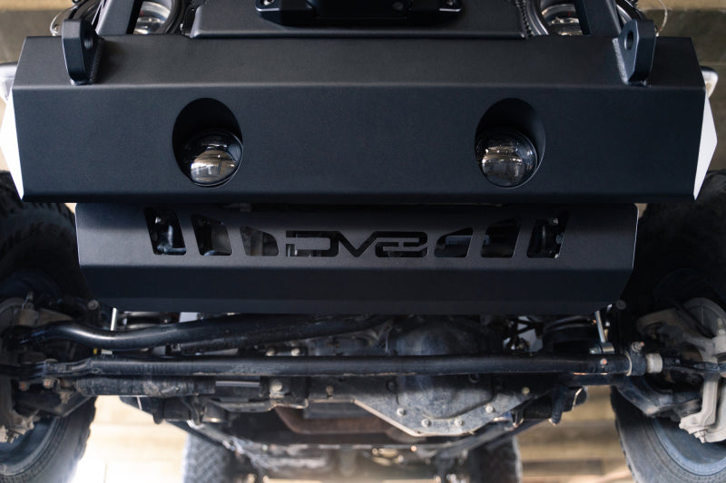 DV8 Offroad Jeep Wrangler JL/JT front bumper sway-bar disconnect motor skid plate in black, showing rugged metal construction and mounting points.