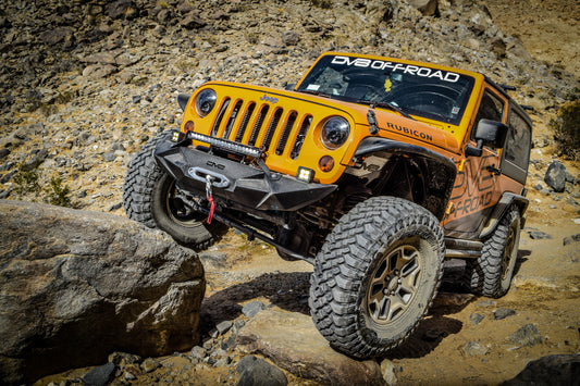 Black aluminum inner fender liner for Jeep Wrangler JK by DV8 Offroad, showing close-up of wheel well with mounting points.