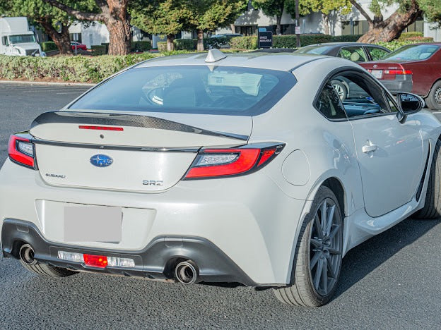 Carbon fiber rear spoiler wing for 2022-up Toyota GR86 and Subaru BRZ, JDM style, installed on sports coupe.