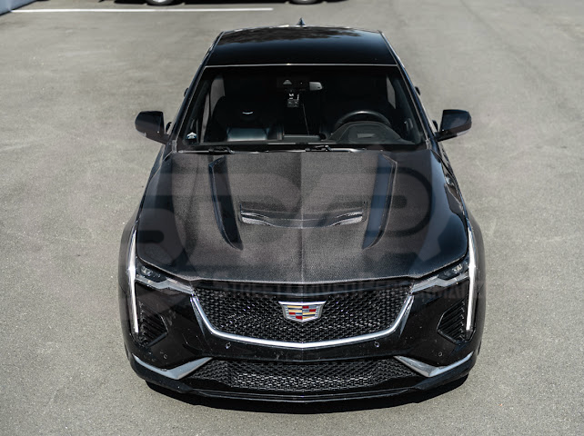 Cadillac CT4 Black Wing hood with black carbon fiber vented front design, featuring sporty styling and aerodynamic enhancements.