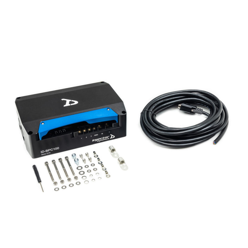 Injector Dynamics 100 AMP brushless pump controller for TI E5LM fuel pump, shown in an automotive setting with wiring and connectors.