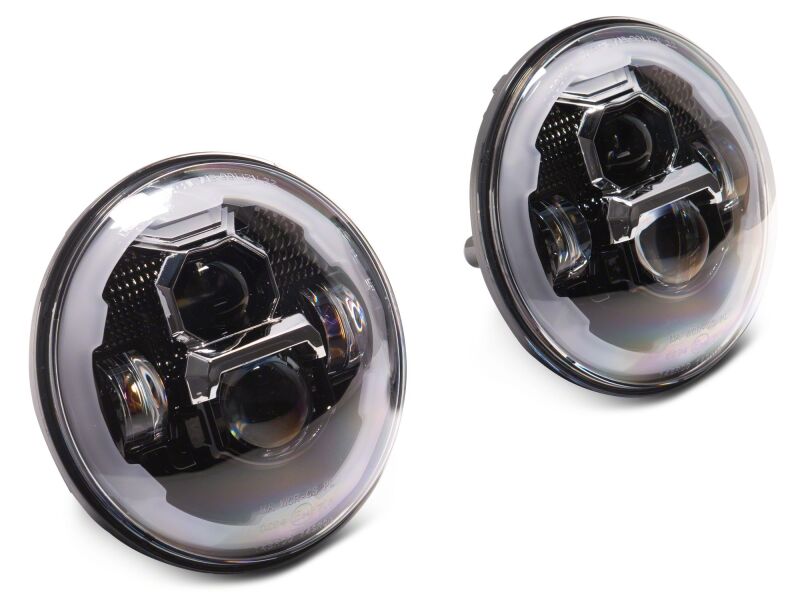Raxiom Jeep Wrangler Axial Series 7-inch LED headlights with black housing and clear lens, featuring daytime running lights.