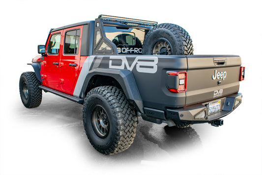 DV8 Offroad Jeep Gladiator universal stand-up in-bed tire carrier mounted on chase rack, designed for 2019+ Jeep Gladiator trucks