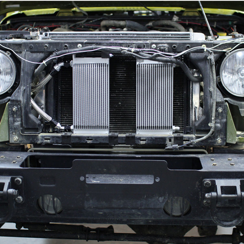 Black Mishimoto oil cooler kit for 2007-2011 Jeep Wrangler JK, featuring thermostatic design and durable construction.