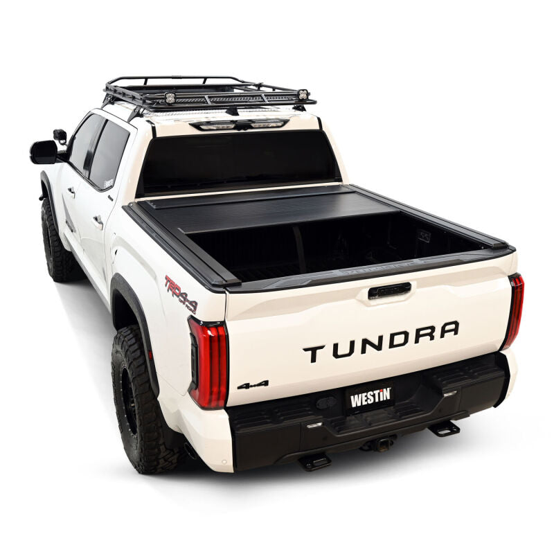 Westin manual retractable black tonneau cover on a 5.5ft bed Toyota Tundra, roll-up style for secure truck bed access.