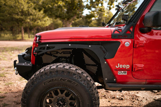 Black DV8 Offroad front inner fenders for 2018+ Jeep Wrangler JL wheel well liners, showing the durable plastic construction.