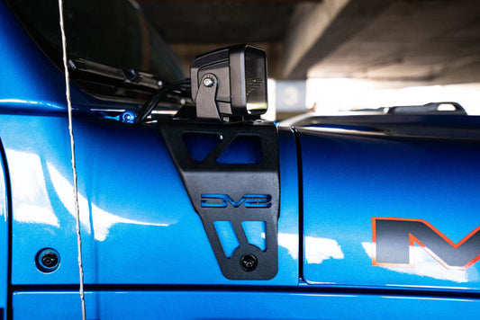 DV8 Offroad Jeep JL 392 and JT Mojave Edition dual pod light mounts installed on the vehicle's front grille.