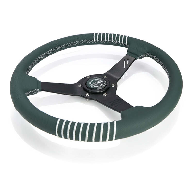 NRG black perforated leather steering wheel with 1.5in dish, 350mm diameter, emerald stitching, reinforced spoke for racing or street use.