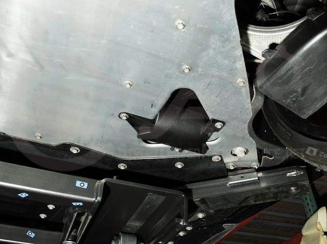Pair of Street Driven Performance Chevrolet Corvette C8 underbody air deflector cooling duct scoops installed on the front underside of the car.