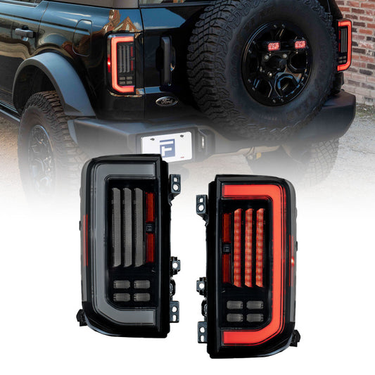 Pair of smoked LED tail lights for 2021-2025 Ford Bronco by FORM Lighting, featuring sleek, modern design with clear lens details.