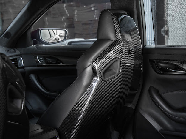 Cadillac ATS-V sedan Recaro carbon fiber seat rear panel cover replacement, showing both driver and passenger side seats.