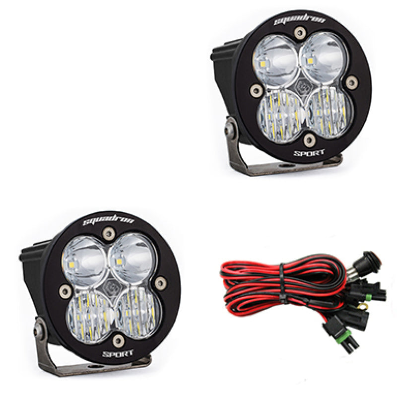 Pair of Baja Designs Squadron R Sport LED light pods for driving and combo lighting, with clear lenses and durable housing.