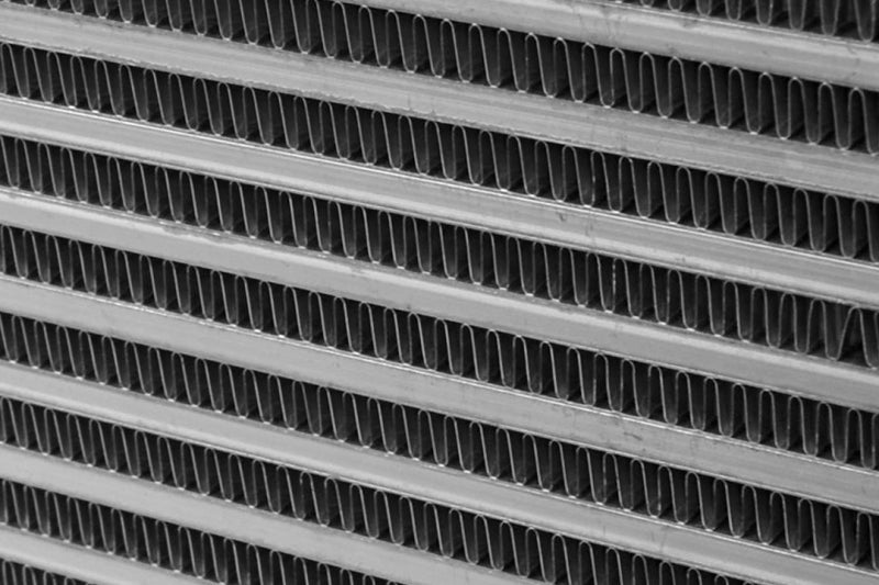 CSF 08-10 Ford Super Duty 6.4L Turbo Diesel Charge-Air-Cooler intercooler showing metal fins and inlet/outlet connections.