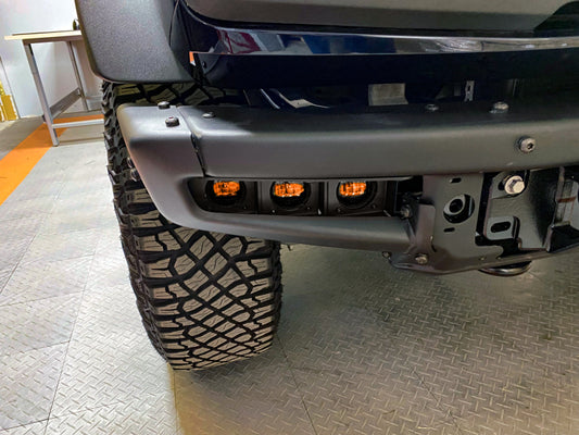 Oracle High 21-22 Ford Bronco triple LED fog lights installed on a steel bumper, showcasing durable off-road lighting.