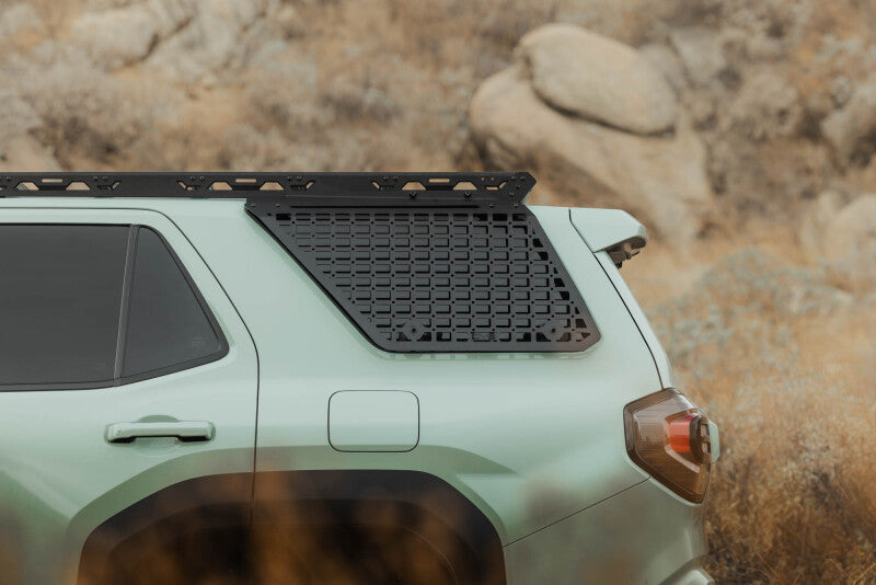 DV8 Offroad Toyota 4Runner exterior window Molle panel for DV8 roof rack, driver side, showing textured black trim.