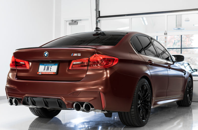AWE Tuning 18-19 BMW M5 F90 axle-back exhaust with diamond black tips, showcasing polished metal and exhaust pipe details.