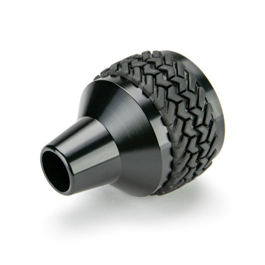 Black DV8 Offroad 2011-2018 Jeep JK 6-speed shift knob, close-up view showing textured surface and shift pattern.