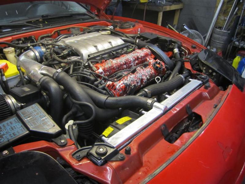 Mishimoto aluminum radiator for 1991-1999 Mitsubishi 3000GT Turbo manual transmission, shown installed in engine bay.