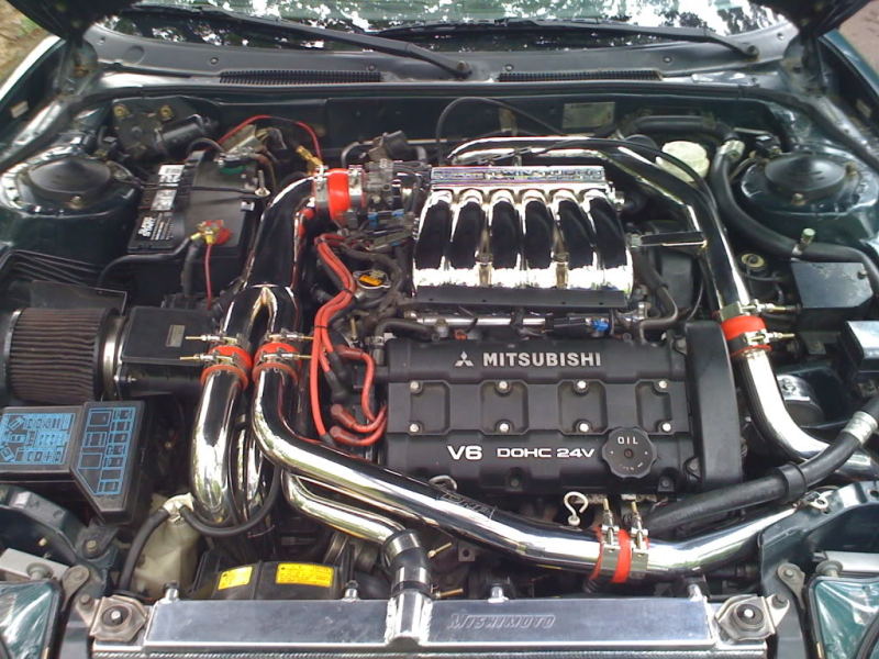 Mishimoto aluminum radiator for 1991-1999 Mitsubishi 3000GT Turbo manual transmission, with cooling fins and inlet/outlet hoses visible