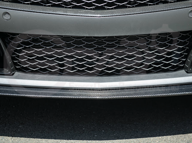 Cadillac CT5-V Blackwing factory OEM style carbon fiber front lip splitter and wheel arches, ground effects on a sleek sports sedan.