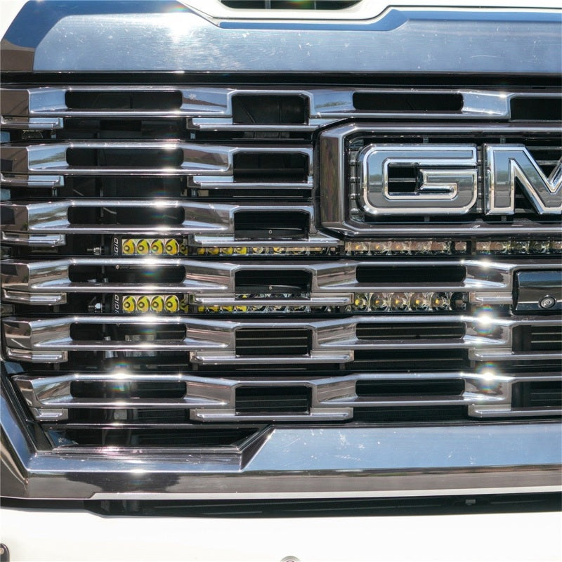 Rigid Industries 24-27 GMC 2500/3500 HD grill radiance kit with light bars and cubes installed on front grille.