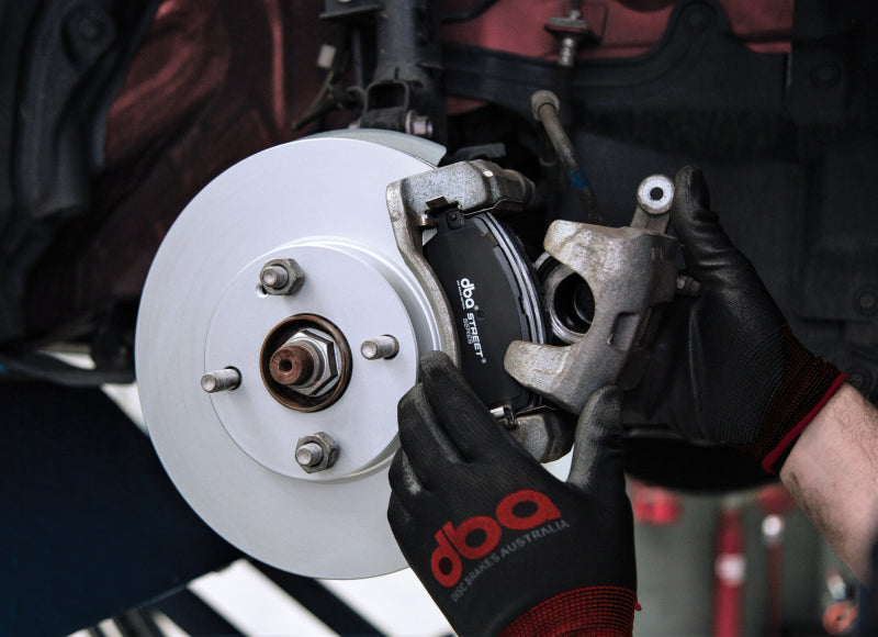 DBA 2019+ Mazda 3 BP Street Series front brake pads, OE style, showing the new brake pad set with metal backing plates and friction material